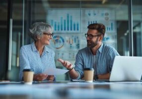 HR managers collaborating on candidate hiring decisions using reference check results.