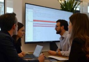 Recruitment team using ATS analytics in a strategy meeting.