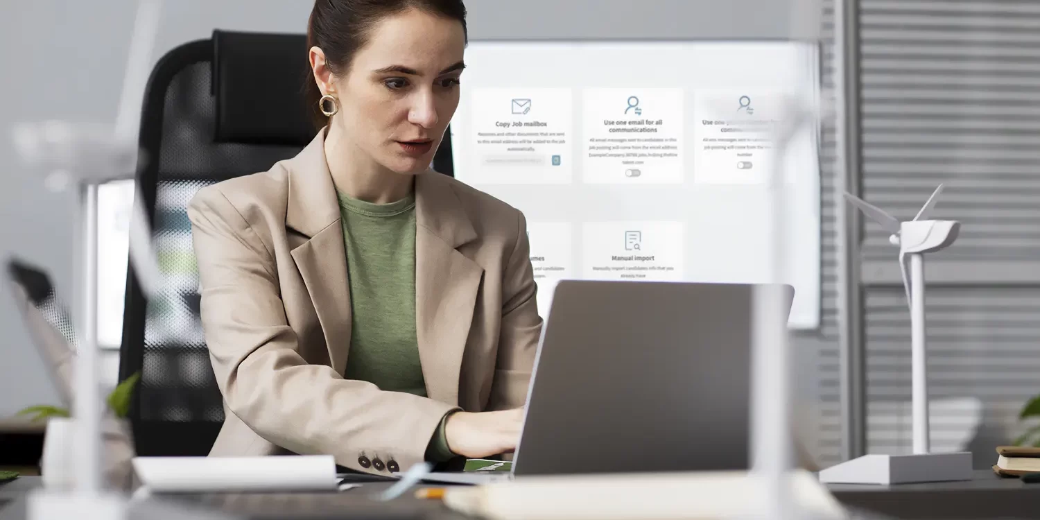 Business professional using recruitment software on laptop with candidate search and evaluation tools for job applications and assessments.